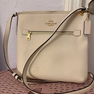 Coach Beige Crossbody Bag with Gold Accents and wallet.